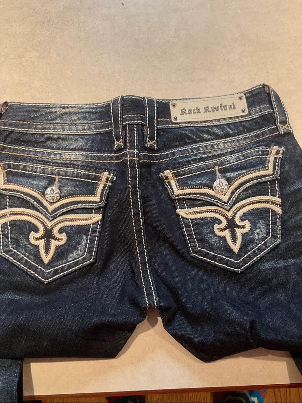 Rock Revival Dark Blue Denim Boot Cut Jeans with Cream Embroidery